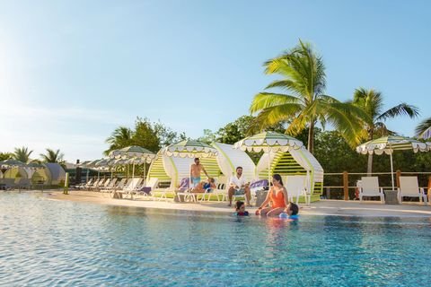 Cabanas and swimmers at the Mangrove Bay pool